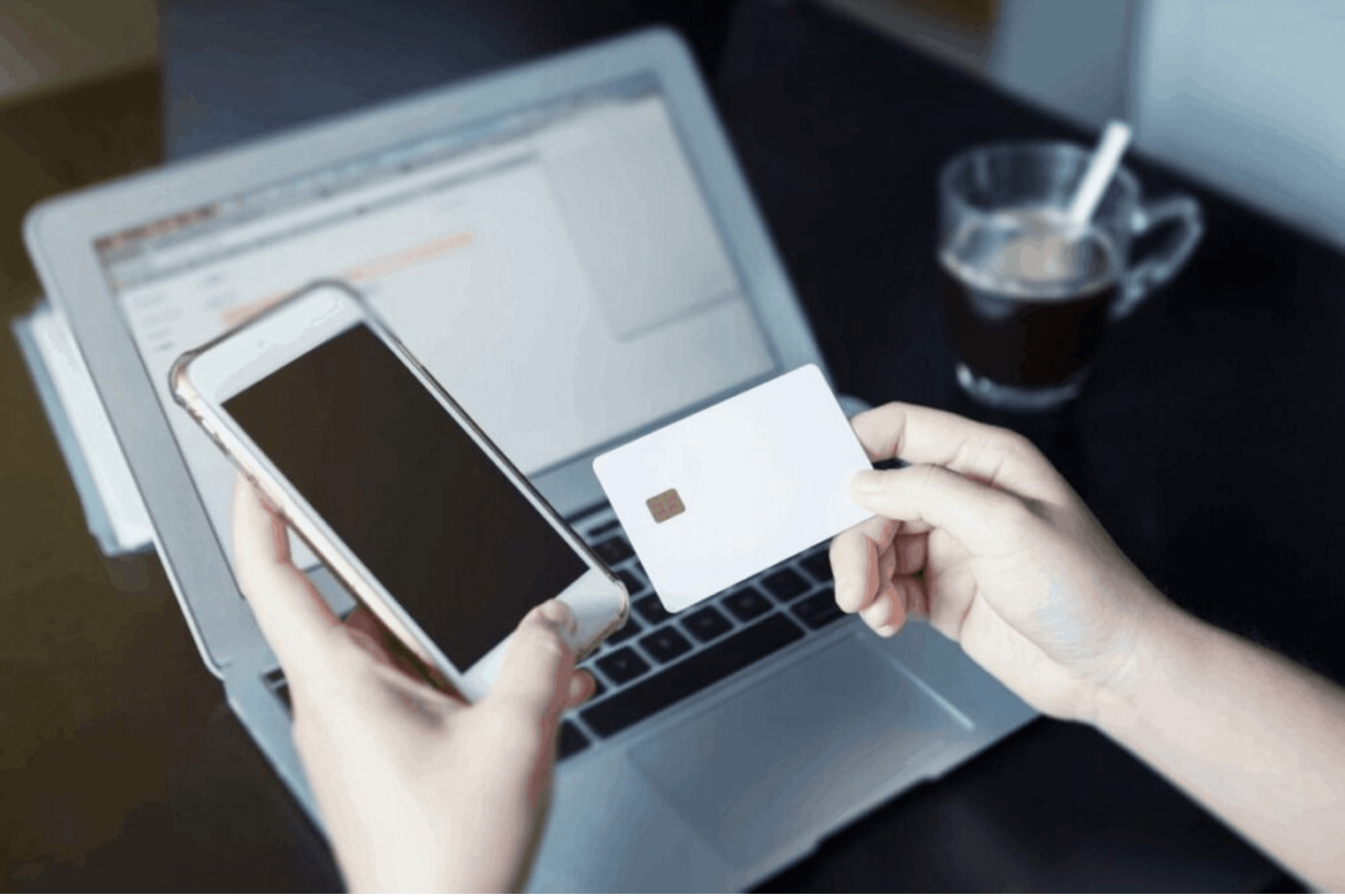 person making an online transaction with phone and credit card