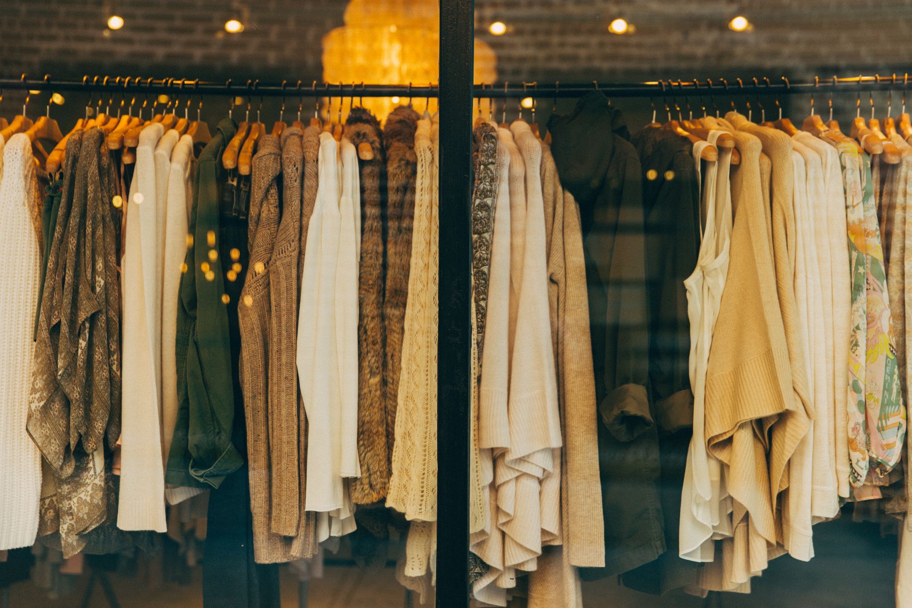Shirts hanging on a clothes rack in a store window