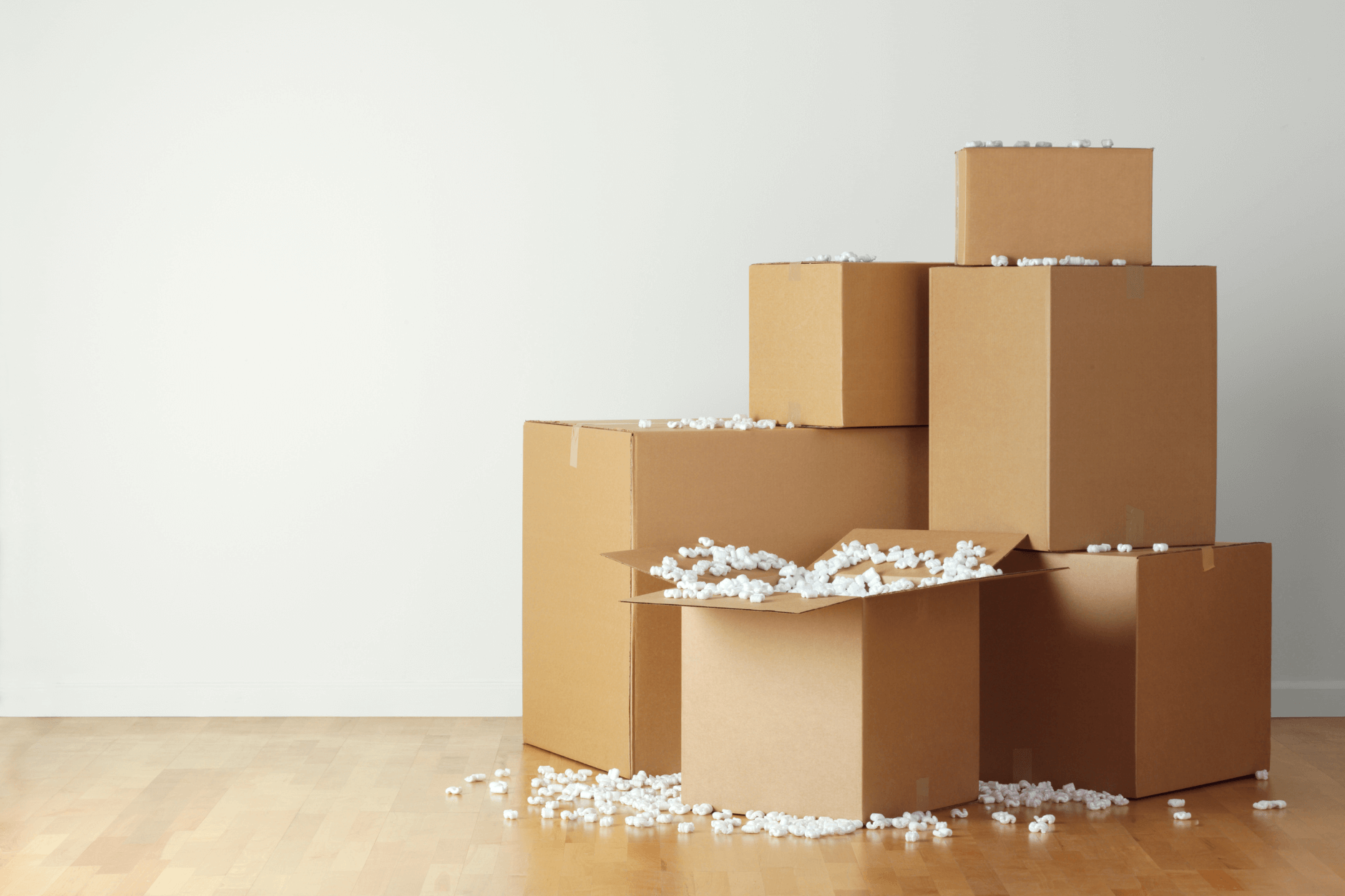 A stack of boxes with packing peanuts spilling out