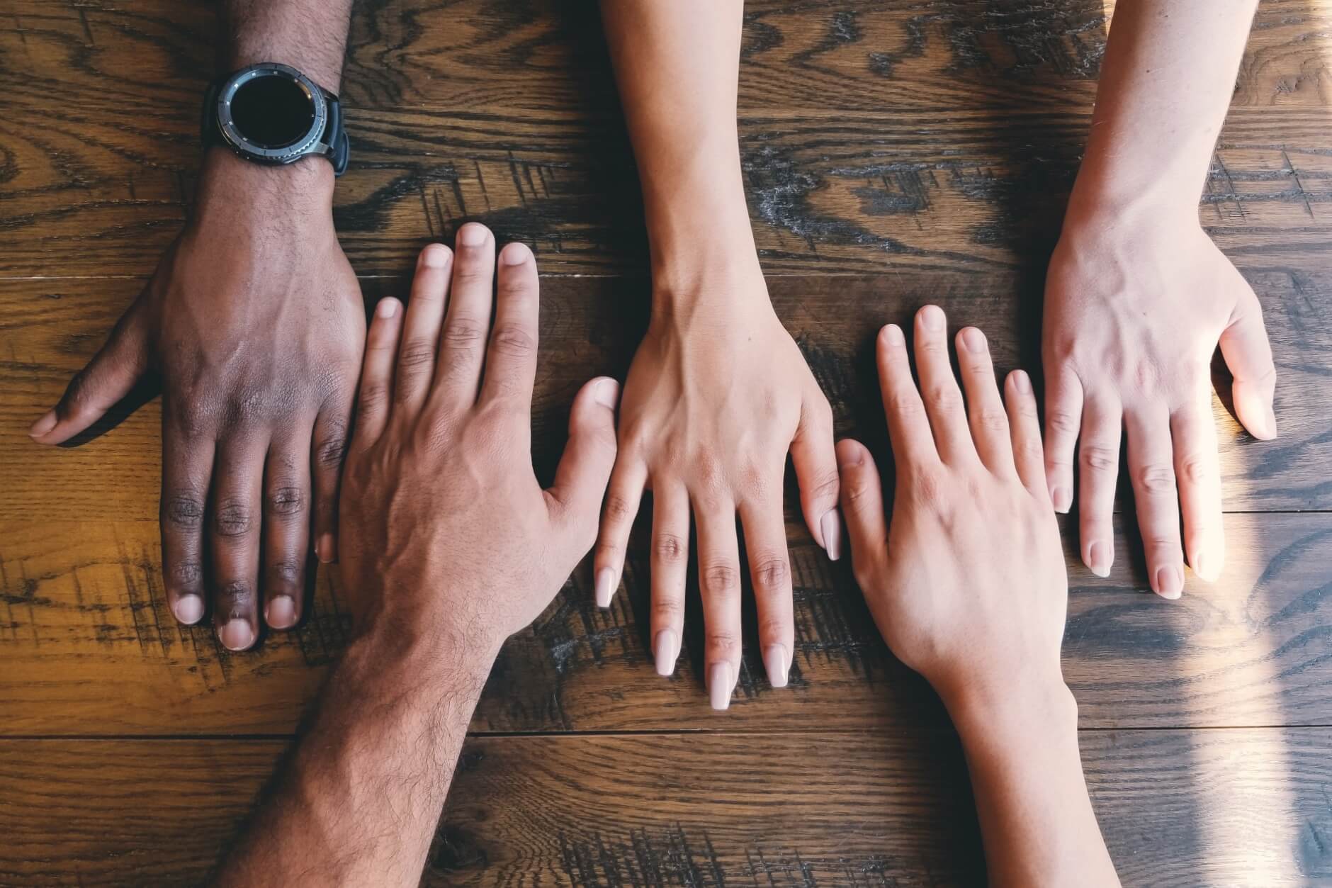 Different peoples's hands on a table
