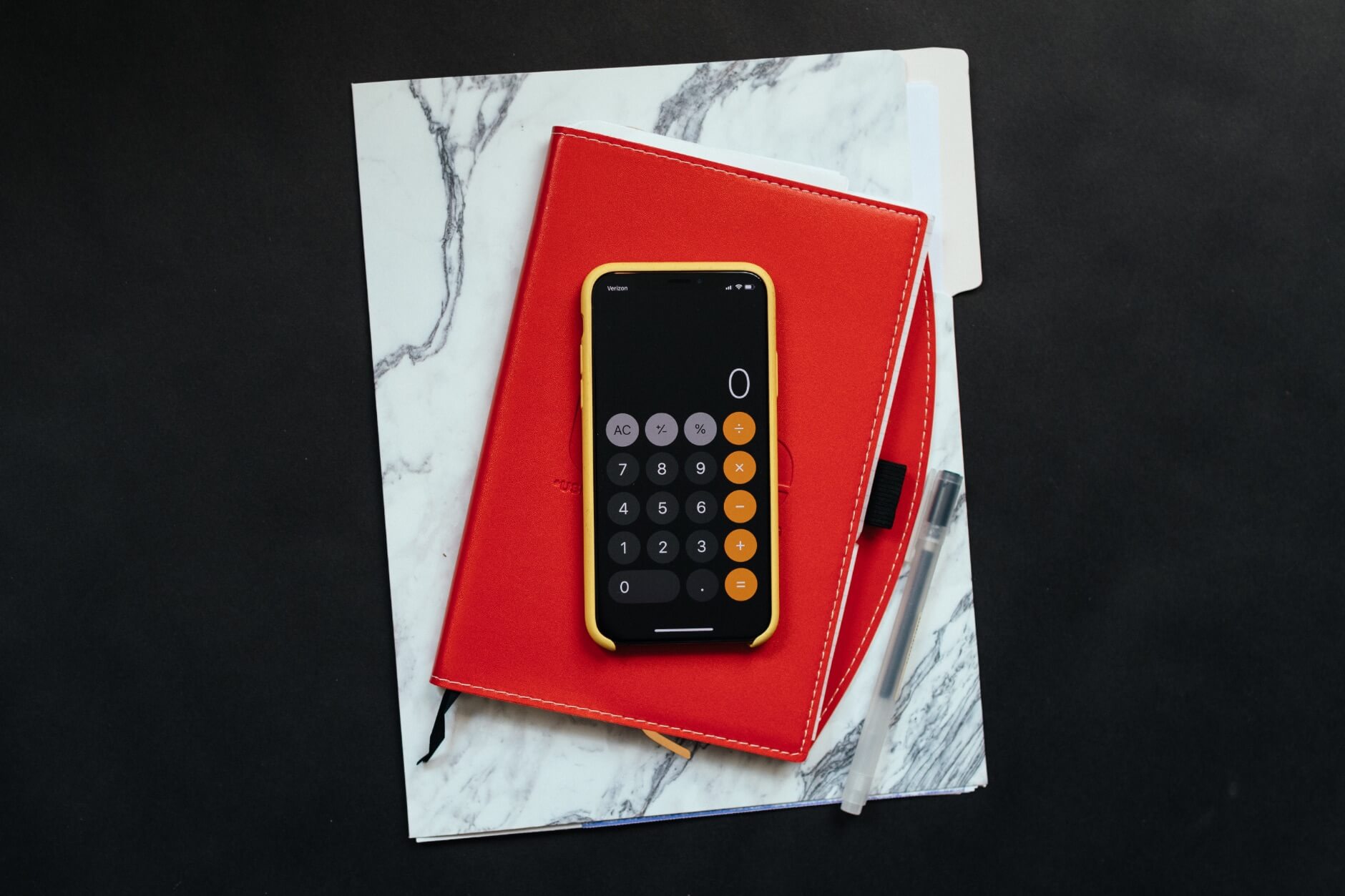 a calculator on top of a file folder